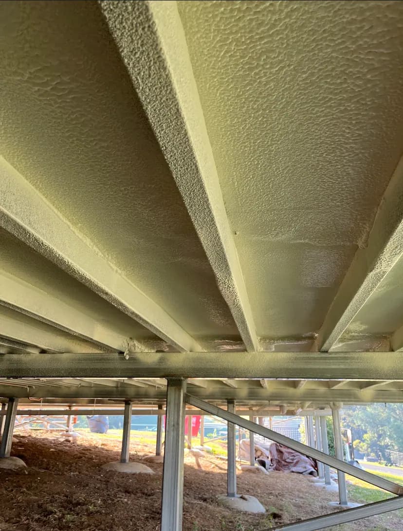 Close view of underfloor insulation held in place between bearers and joists