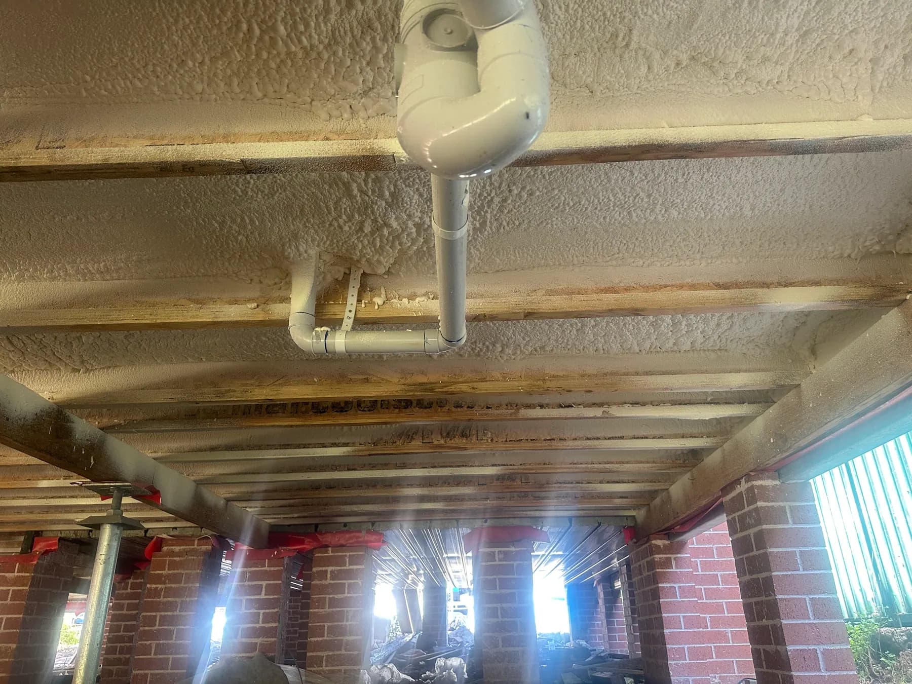Closed-cell spray foam applied to the underside of a timber floor