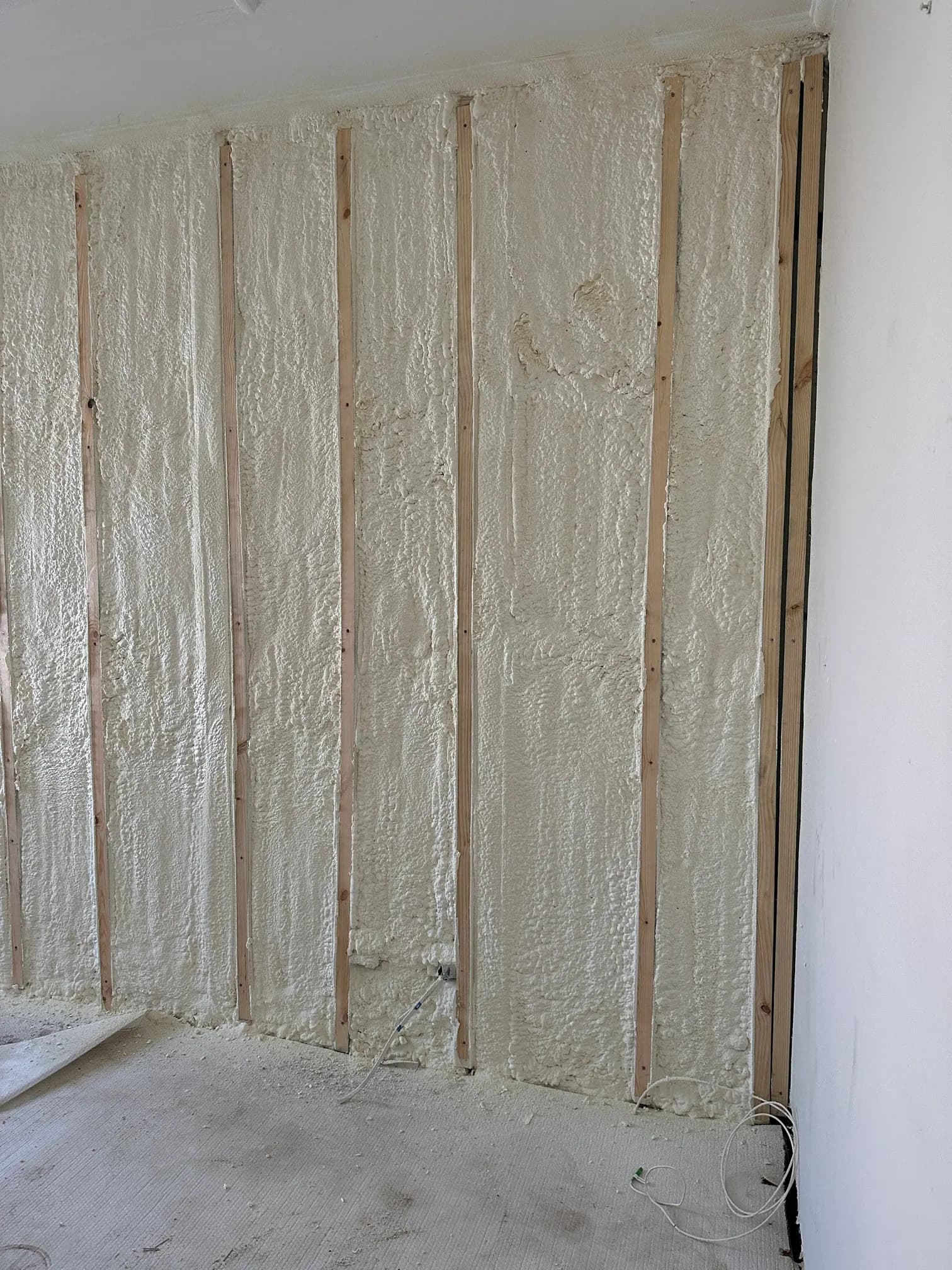 Spray foam insulation applied inside a framed wall