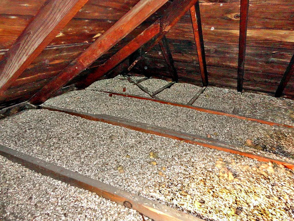 Old loose-fill insulation in a roof space that should be checked for asbestos