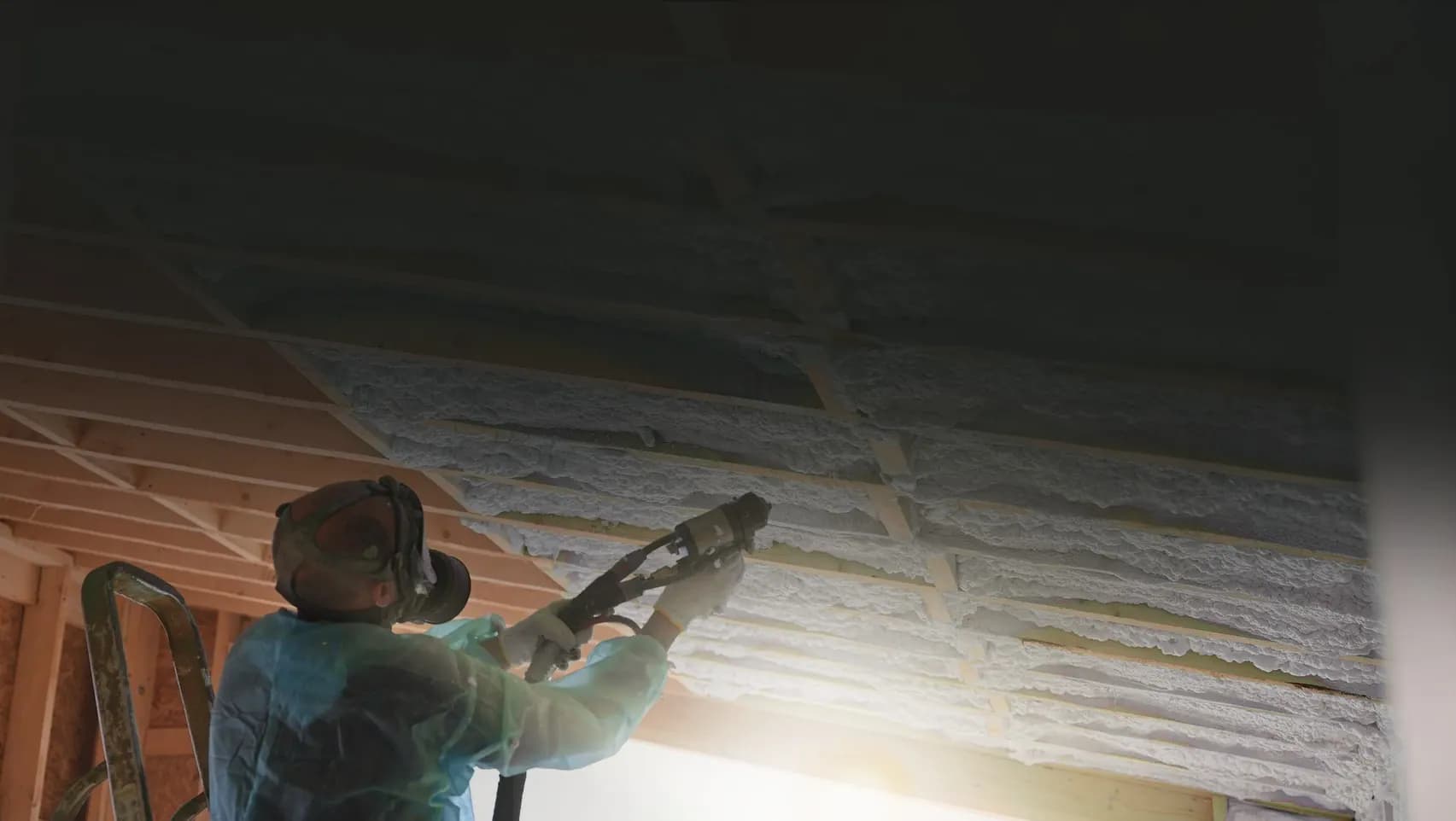 Insulation batts fitted between timber floor joists under a house