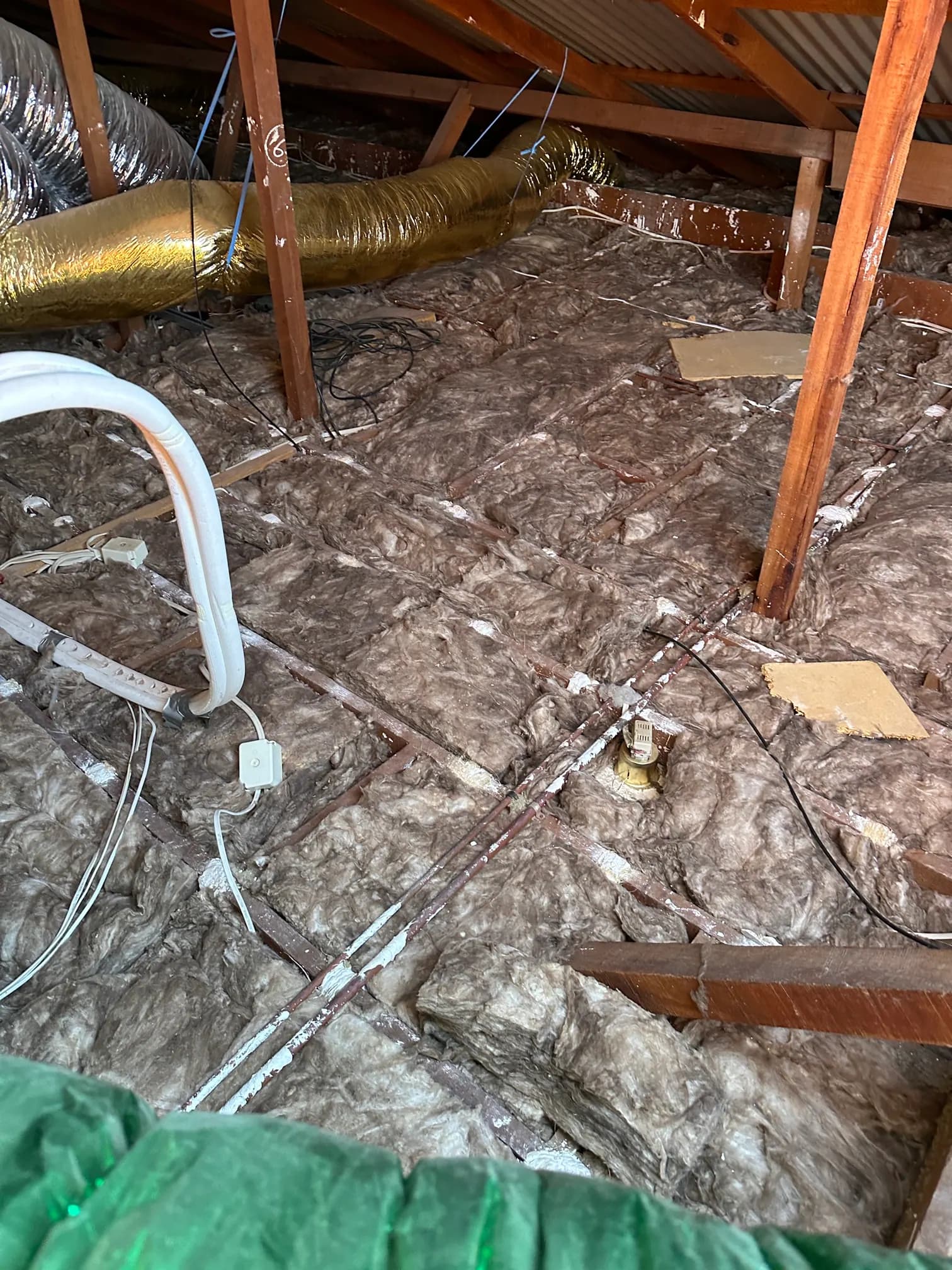 Earthwool batts being installed in a residential roof space